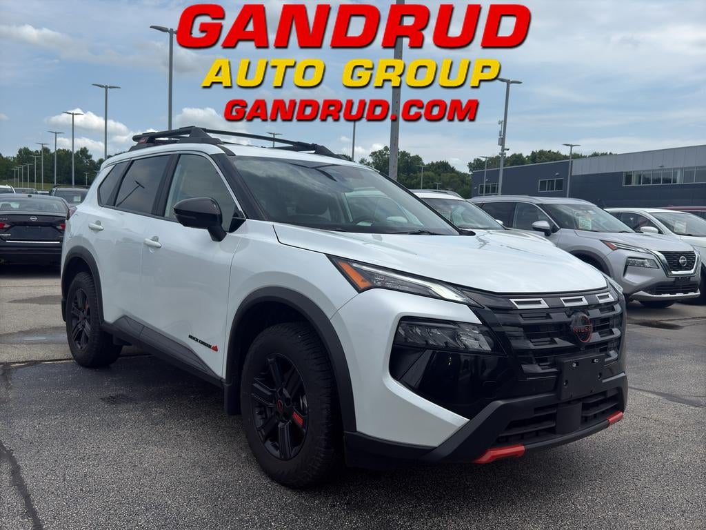 2025 Nissan Rogue Rock Creek in Everest White Pea — front three-quarter view